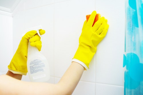 Cleaner performing detailed end of tenancy cleaning in a bedroom